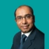 Consultant headshot of Arun Bhaskar, on a green background