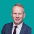 A headshot of consultant Jonathan Bird, on a green background