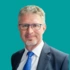 A headshot of consultant Paul Foster, on a green background