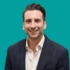 A headshot of consultant Nick Aresti, on a green background