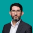 A headshot of Professor Nima Heidari, on a green background