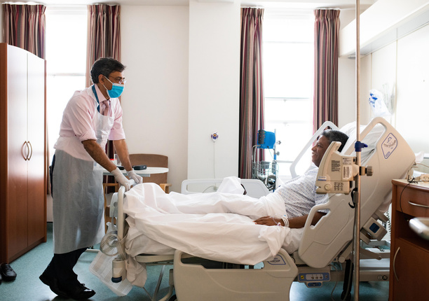 Doctor stands by patient bed