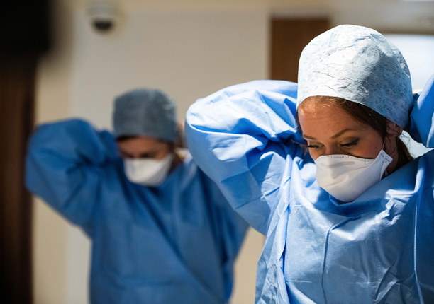 Nurses putting on PPE