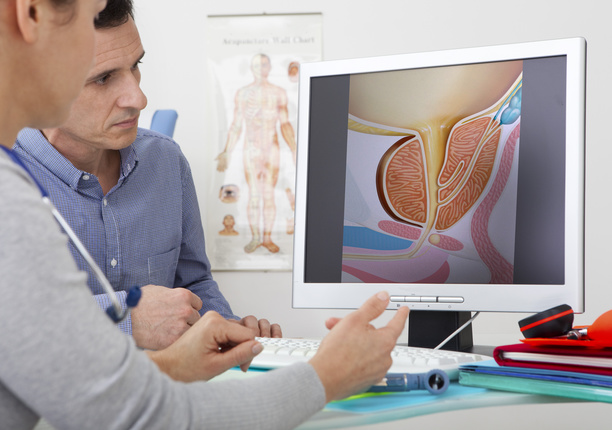 An image of a doctor with a patient reviewing a urology scan