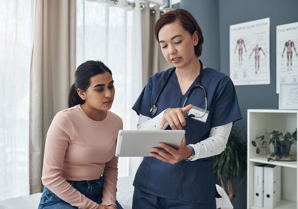 Patient and nurse looking at paperwork together