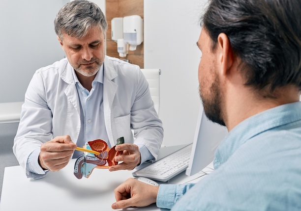 Consultant discussing the need for a prostate biopsy with the patient, a crucial step in prostate cancer diagnosis.