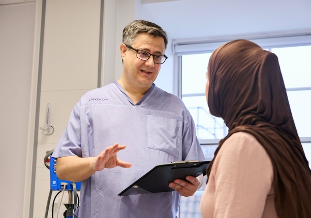 A consultant talking through a document with a patient