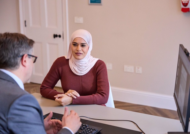 A photo with the focus on a patient (model), with a consultant