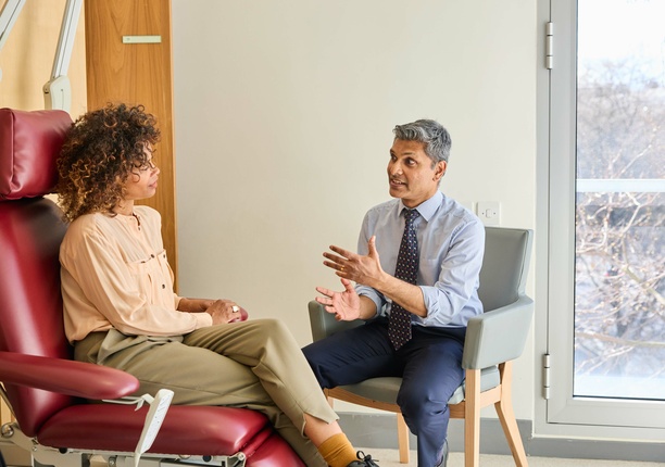 A London Clinic Lung Centre consultant discussing treatment options with a patient, sat in a chair looking out at the window happy!