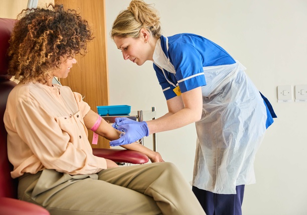 A photo of a patient receiving a treatment, with a nurse providing comfort, at The London Clinic Lung Centre
