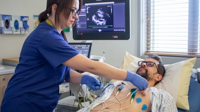 An image of a doctor and patient. Patient receiving a cardiology diagnostic test