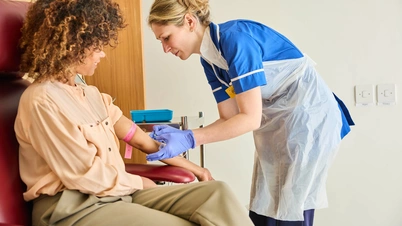 A photo of a patient receiving a treatment, with a nurse providing comfort, at The London Clinic Lung Centre