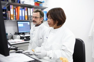 Research colleagues looking at computer screen