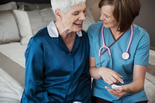 Doctor sits with patient