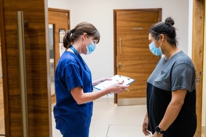 A nurse and patient going through a form
