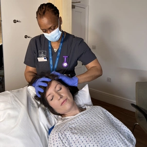 Jay using Indian head massage techniques on a patient