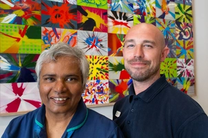 Anita and Dom stand by the spin artwork created on International Nurses Day.