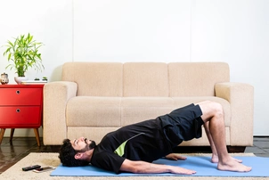 Man does pelvic floor stretches in lounge