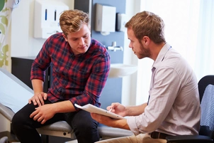 Male patient with doctor in consultation