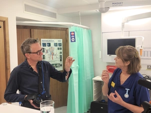 An image of Dr Michael Mosley at The London Clinic, holding a small capsule endoscopy and camera, to check on his bowel health. Featuring a London Clinic nurse