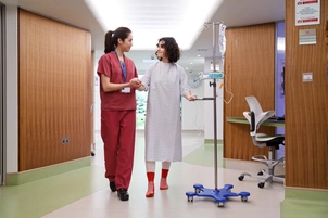 Patient walking in gown in hallway