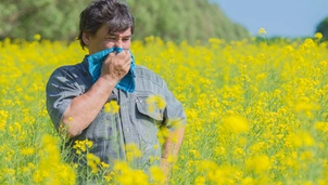 a man stands in a field filled with pollen