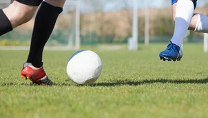 two footballers prepare to tackle