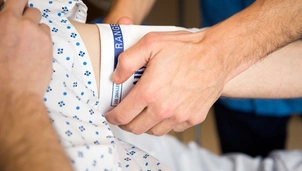 Patient gets arm band placed on by nurse
