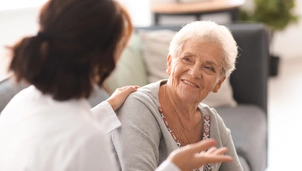 A patient smiling at a GP