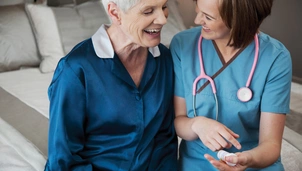 Doctor sits with patient