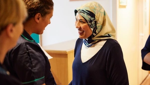 A member of staff greeting a patient