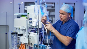 A surgeon completing robotic surgery