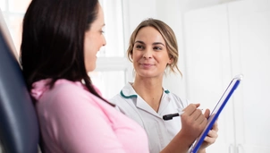 A physiotherapist and a patient going through a form