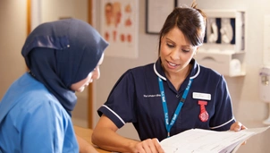 Two nurses going through documents