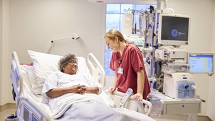 A patient talking to and smiling at a nurse
