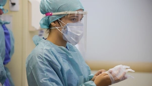 A doctor putting their gloves on before surgery