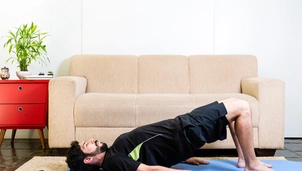 Man does pelvic floor stretches in lounge