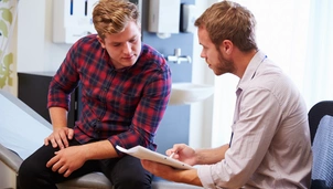 Male patient with doctor in consultation