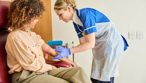 A photo of a patient receiving a treatment, with a nurse providing comfort, at The London Clinic Lung Centre