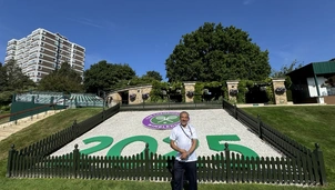 Podiatrist Saj at Wimbledon, standing in front of the 2025 Welcome Sign! 