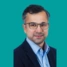 A headshot of consultant Aminul Ahmed, on a green background