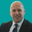 Headshot of consultant Marco Scarci on a green background