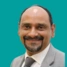 Headshot of consultant Mr Shahnawaz Rasheed on a green background