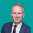 A headshot of consultant Jonathan Bird, on a green background