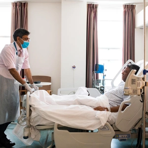 Doctor stands by patient bed
