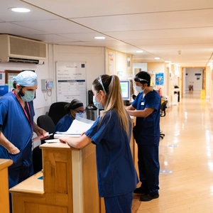 Nurses and doctors gathered round a reception