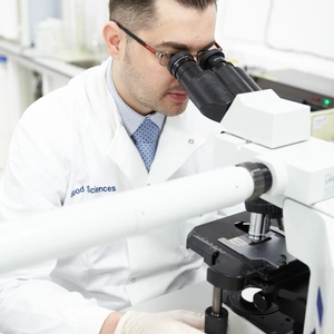 Man looking into a microscope