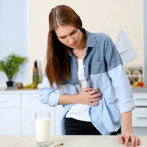 Women holds stomach in pain