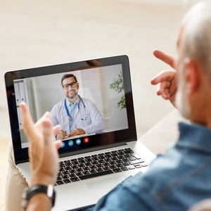 Man makes video call with doctor