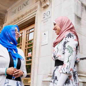 A member of staff and international patient outside the door